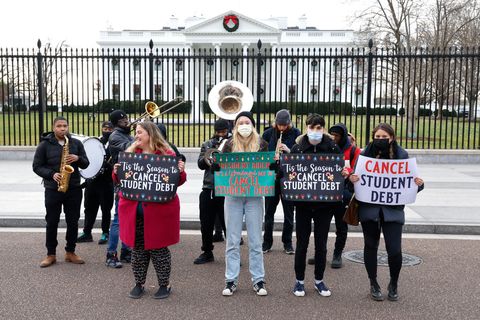 washington, dc   december 15 activists hold festive signs calling on president biden to cancel student debt and not resume student loan debt while musicians play joyful music, greeting the white house staff as they arrive to work on december 15, 2021 in washington, dc photo by paul morigigetty images for we, the 45 million