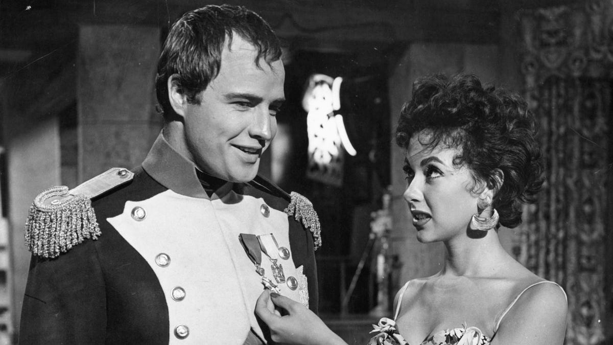 Marlon Brando and Rita Moreno visit on the set of the film 'Desiree.'