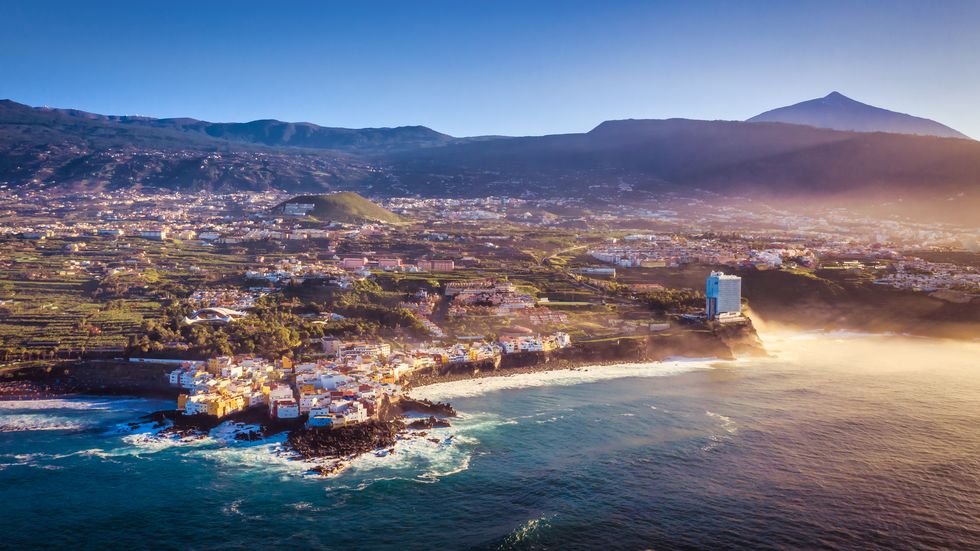 beach and mountain landscape with the teide with drone of the tourist city of puerto de la cruz on the island of tenerife