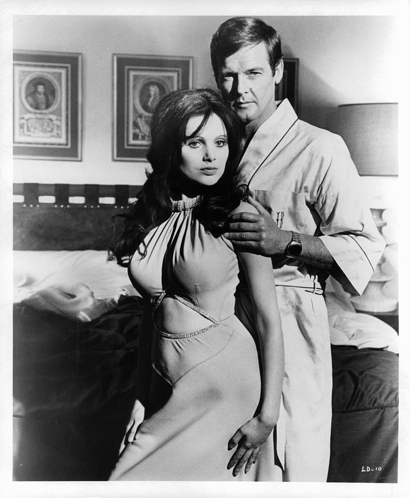 madeline smith leaning against roger moore in a suggestive manner as he touches her arm in a scene from the film live and let die, 1973 photo by united artistgetty images