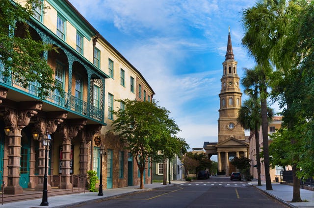 Historic street scene featuring a clock tower and buildings with intricate architectural details
