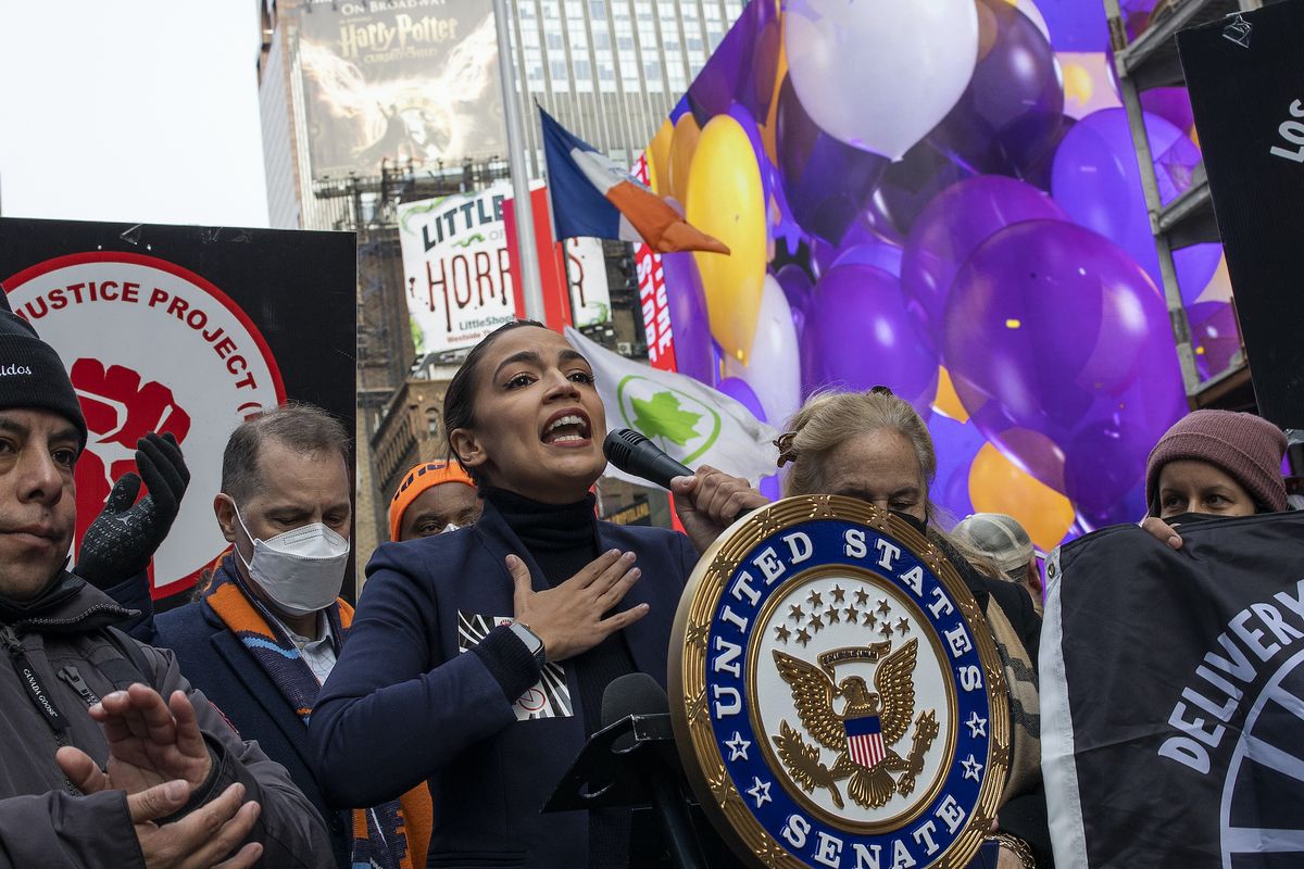 new york, new york   january 23 congresswoman alexandria ocasio cortez joins delivery workers to celebrate the passage of legislation by the new york city council guaranteeing them basic labor rights such as wages, tips, and rest areas, january 23, 2022 in times square, new york city photo by andrew lichtensteincorbis via getty images