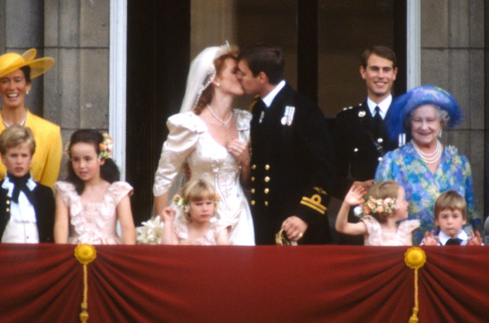 london, england july 23 prince andrew, duke of york and sarah ferguson, duchess of york share a kiss, on their wedding day, as mother of the bride, susan barrantes l, page boy, peter phillips 2nd l, bridesmaids, lady rosanagh innes ker 3rd l and zara phillips 4th l, prince edward 4th r, bridesmaid, laura fellowes 3rd r, queen elizabeth the queen mother 2nd r and page boy prince william r look on from the balcony at buckingham palace on july 23, 1986 in london, united kingdom photo by anwar husseingetty images