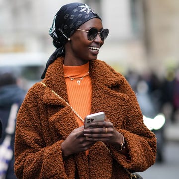 a woman in a brown coat