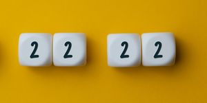 numbers 2 22 22 on white cubes shapes on yellow background