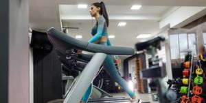 young sportswoman running on treadmill in a gym