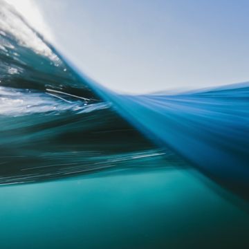 vortex split view of blue ocean waters below and above surface