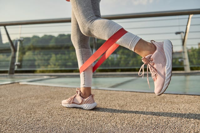 a person uses a resistance band on their legs