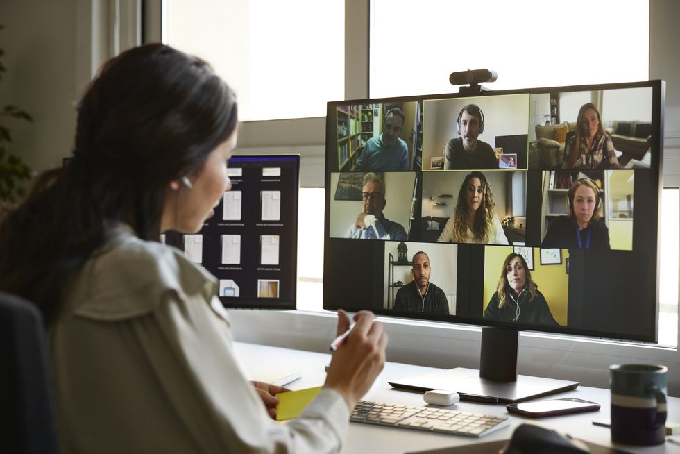 businesswoman discussing with colleagues during video conference male and female entrepreneurs attending online meeting they are planning business strategy