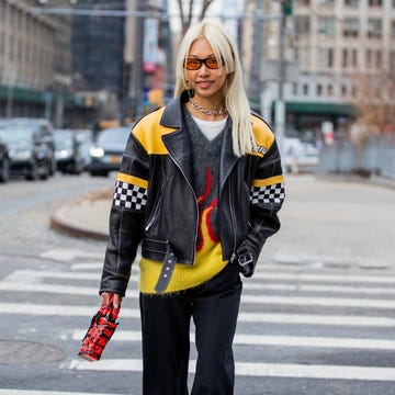 new york, new york   february 16 vanessa hong seen with edge cut hair wearing black racing leather jacket, grey yellow cashmere jumper, red black mini bag, wide leg pants, sunglasses outside prabal gurung during new york fashion week on february 16, 2022 in new york city photo by christian vieriggetty images