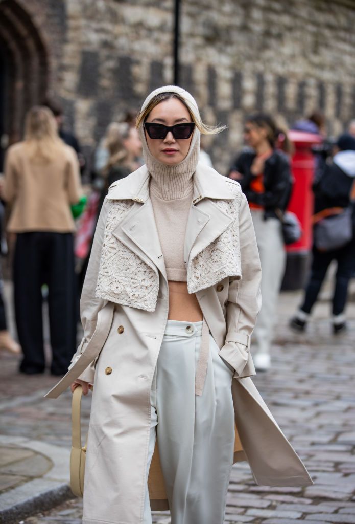 london, england   february 19 betty bachz seen wearing cropped jumper with balaklava, trench coat, creme white pants, beige bag, sunglasses outside eudon choi during london fashion week february 2022 on february 19, 2022 in london, england photo by christian vieriggetty images