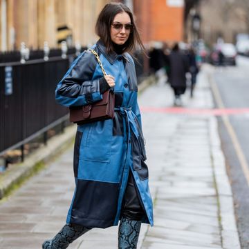 london, england   february 20 a guest is seen wearing checkered navy blue coat, brown bag, boots with snake print outside 16arlington during london fashion week february 2022 on february 20, 2022 in london, england photo by christian vieriggetty images