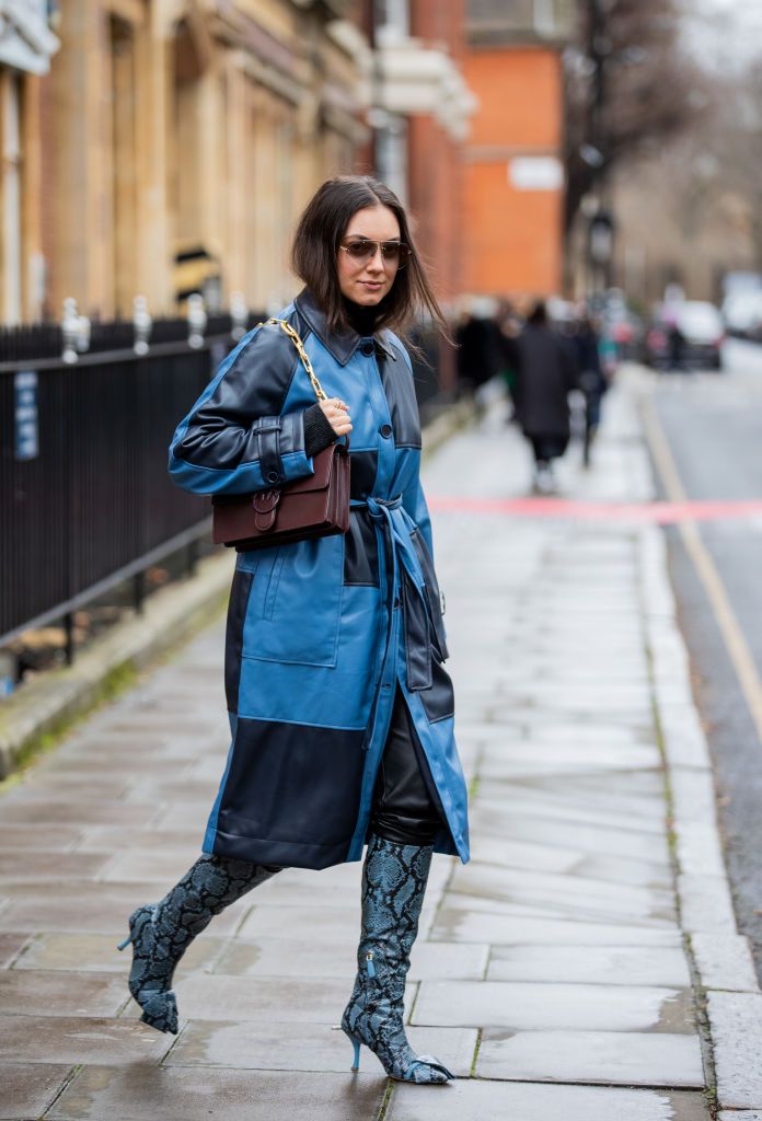 london, england   february 20 a guest is seen wearing checkered navy blue coat, brown bag, boots with snake print outside 16arlington during london fashion week february 2022 on february 20, 2022 in london, england photo by christian vieriggetty images