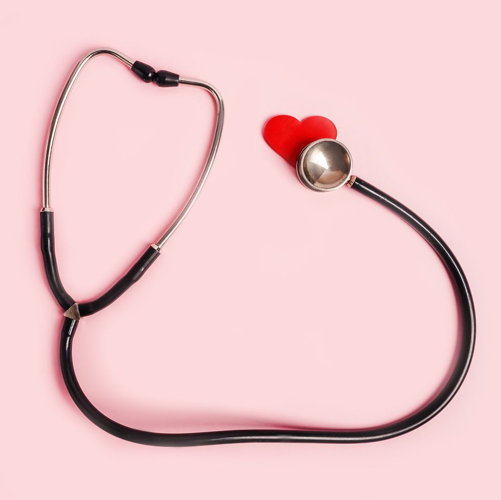 medical stethoscope with red hearts flat lay on pink background nurses day concept