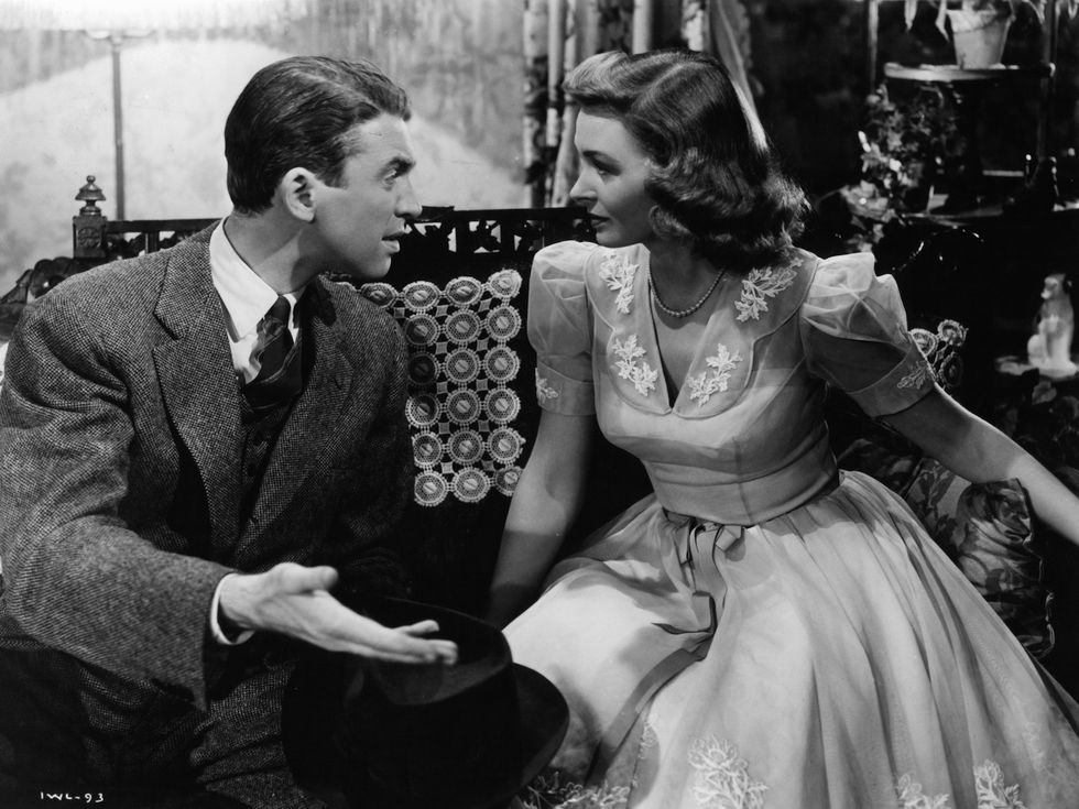 james stewart sitting and talking with donna reed in a scene from the film 'it's a wonderful life', 1946 photo by rko radio picturegetty images