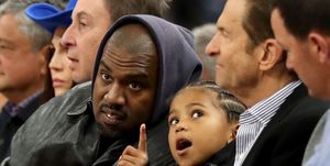 san francisco, california march 16 kanye west, center, and his son, saint west, got front row seats next to golden state warriors co owners joe lacob and peter guber as they watch the game against the boston celtics in the second quarter at chase center in san francisco, calif, on wednesday, march 16, 2022 photo by ray chavezmedianews groupthe mercury news via getty images