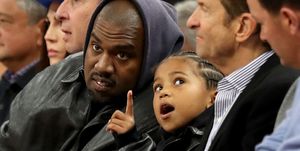 san francisco, california march 16 kanye west, center, and his son, saint west, got front row seats next to golden state warriors co owners joe lacob and peter guber as they watch the game against the boston celtics in the second quarter at chase center in san francisco, calif, on wednesday, march 16, 2022 photo by ray chavezmedianews groupthe mercury news via getty images