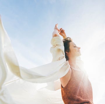 Dreamy portrait of a young woman against the blue sky. dreamy portrait of a young woman against the blue sky feeling full of confidence