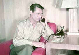 cary grant 1904 1986, british actor, sitting on a red sofa as he holds a telephone receiver to his ear, circa 1950 photo by silver screen collectiongetty images