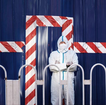 beijing, china   march 21 a guard wears a protective suit as he watches over a barricaded community that was locked down for health monitoring after recent cases of covid 19 were found in the area on march 21, 2022 in beijing, china china has stepped up efforts to control a recent surge in coronavirus cases across the country, locking down the entire province of jilin and putting cities like shenzhen and shanghai under restrictions and is carrying out mass testing in other centres as the country tries to maintain its zero covid policy photo by kevin frayergetty images