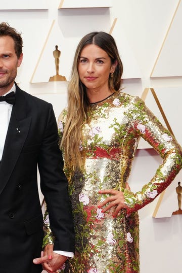 hollywood, california   march 27 l r jamie dornan and amelia warner attend the 94th annual academy awards at hollywood and highland on march 27, 2022 in hollywood, california photo by jeff kravitzfilmmagic