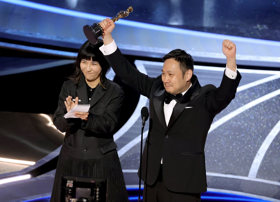 hollywood, california   march 27 ryusuke hamaguchi r accepts the international feature film award for ‘drive my car’ onstage during the 94th annual academy awards at dolby theatre on march 27, 2022 in hollywood, california photo by neilson barnardgetty images