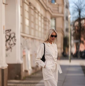 berlin, germany march 28 lena gercke seen wearing a white denim overall from leger, a black sunglasses from prada, silver earrings from leger, a black handbag from leger and black leather boots from leger on march 28, 2022 in berlin, germany photo by jeremy moellergetty images