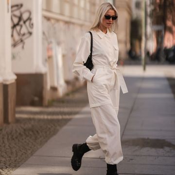berlin, germany march 28 lena gercke seen wearing a white denim overall from leger, a black sunglasses from prada, silver earrings from leger, a black handbag from leger and black leather boots from leger on march 28, 2022 in berlin, germany photo by jeremy moellergetty images