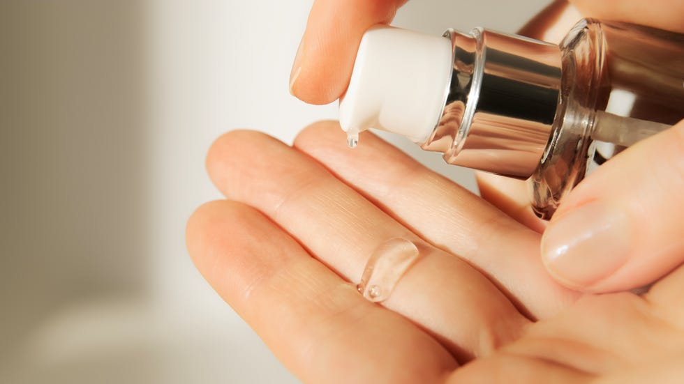 push dispenser liquid facial fluid gel squeezed out to hand cosmetologist pours clear cleansing moisturizing hyaluronic serum acid cosmetic concept