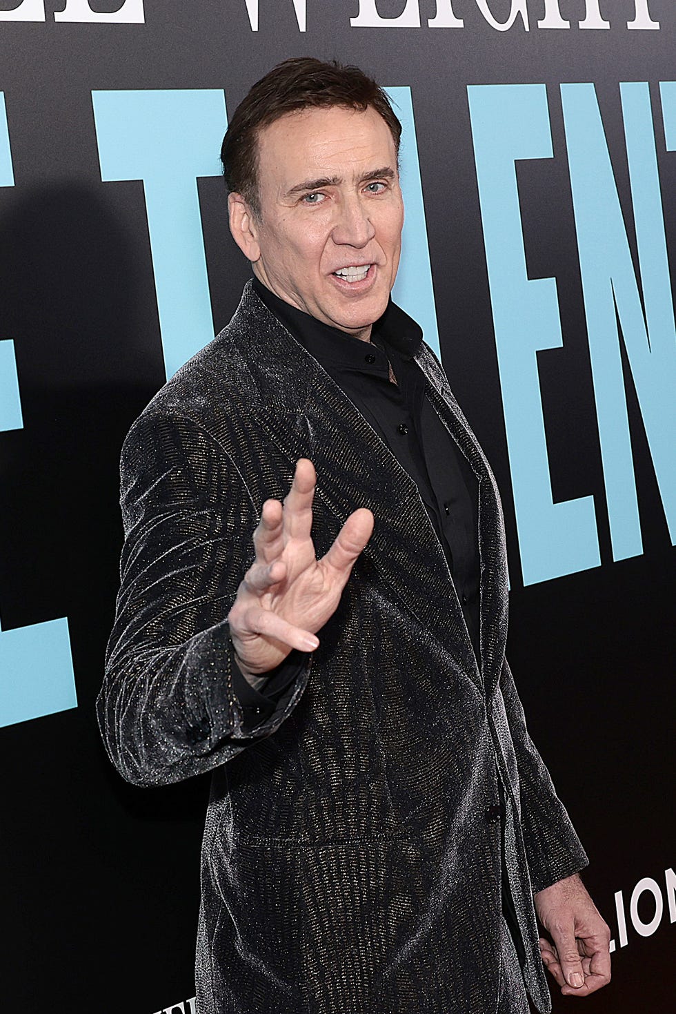 Nicolas Cage saludando en el estreno de una película.