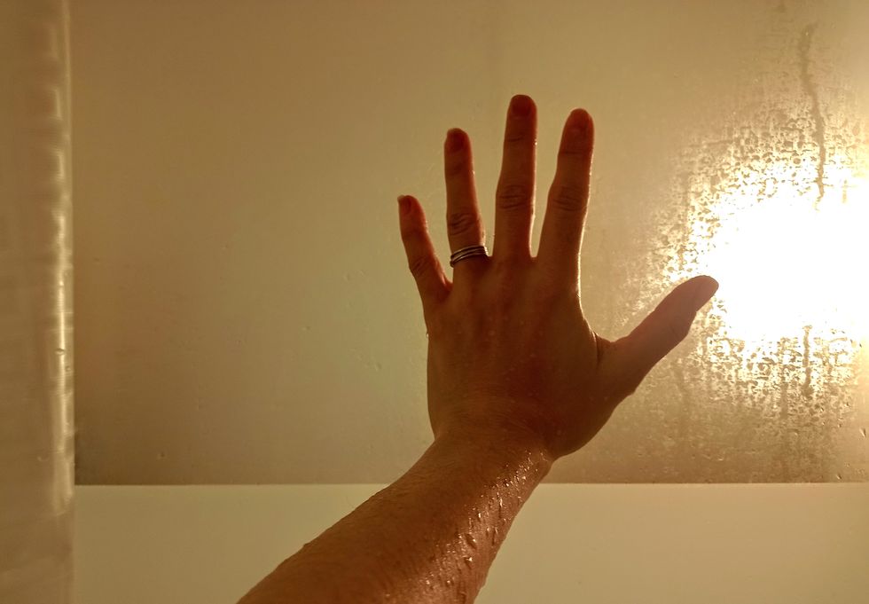 a hand with a bright light behind it