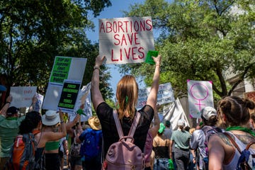 abortion rights activists and supporters march outside of the austin convention center