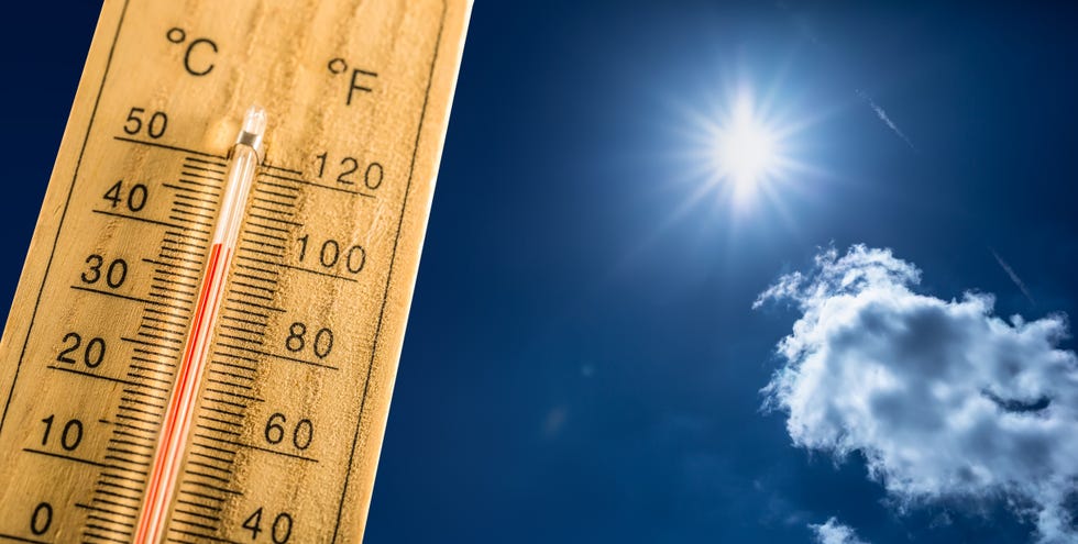 hot summer day and forty degrees celsius on a thermometer thermometer in summer day shows high temperature degree with sun in background