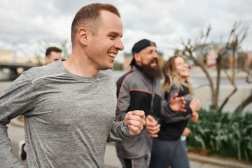 group of individuals running in an outdoor setting