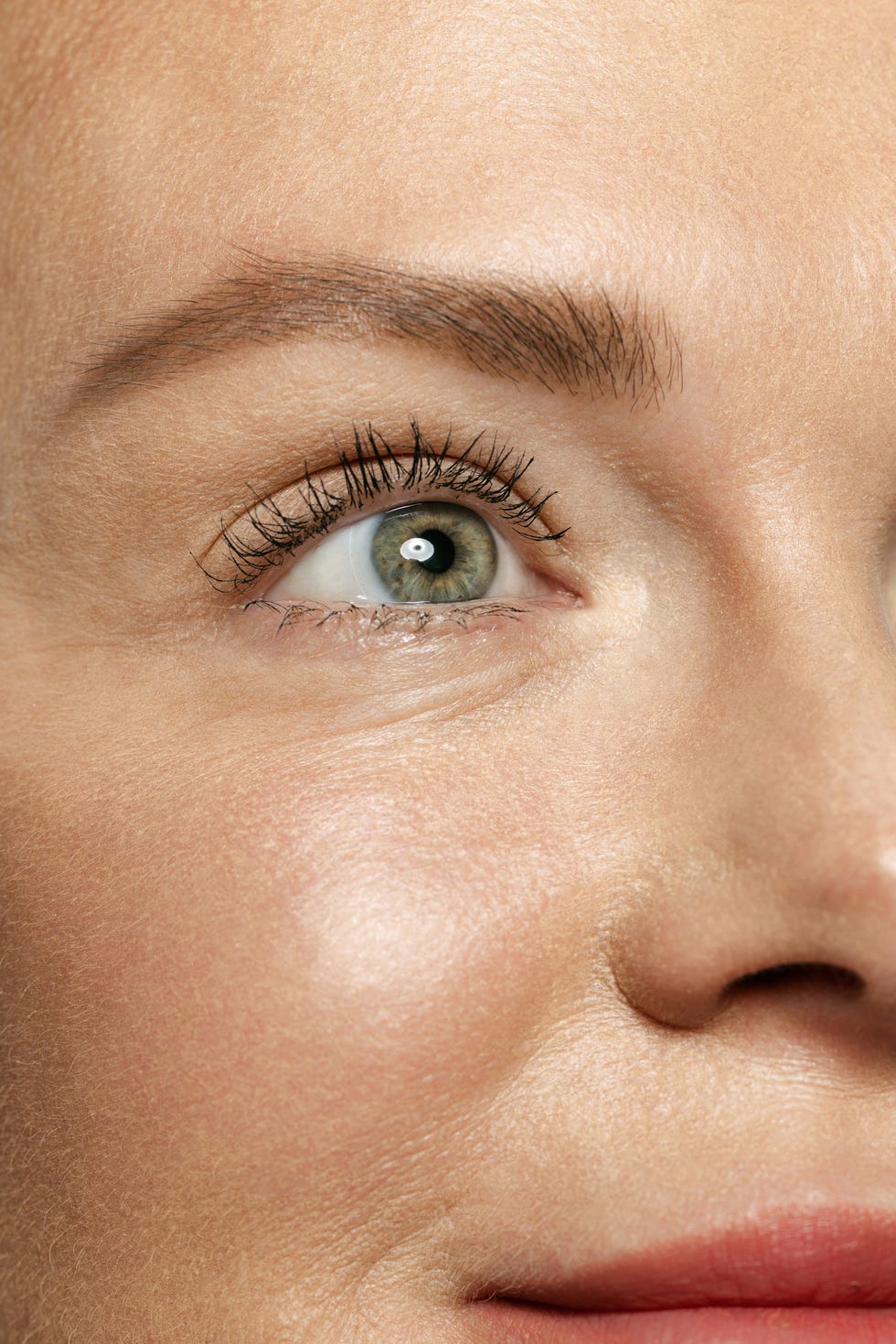close up portrait of young womans eyes with first wrinkles female model with well kept skin concept of womens health and beauty, cosmetology, cosmetics, self care, skin care anti aging