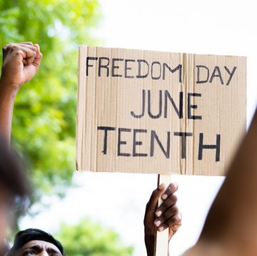 concept of juneteenth freedom day march showing by close up protesting hands sign board concept of activism, justice and demonstration