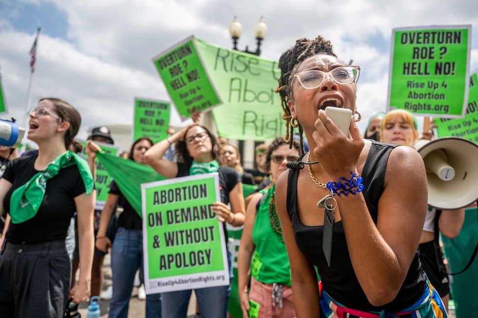 abortion rights demonstrator elizabeth white leads a chant in response to the dobbs v jackson women's health organization ruling in front of the us supreme court