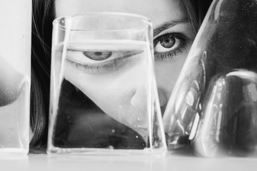 portrait of woman through glass of water