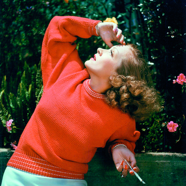 marlene dietrich 1901 1992, german actress and singer, wearing a red jumper as she looks toward the sky, shielding her eyes and holding a cigarette, circa 1940 photo by silver screen collectiongetty images