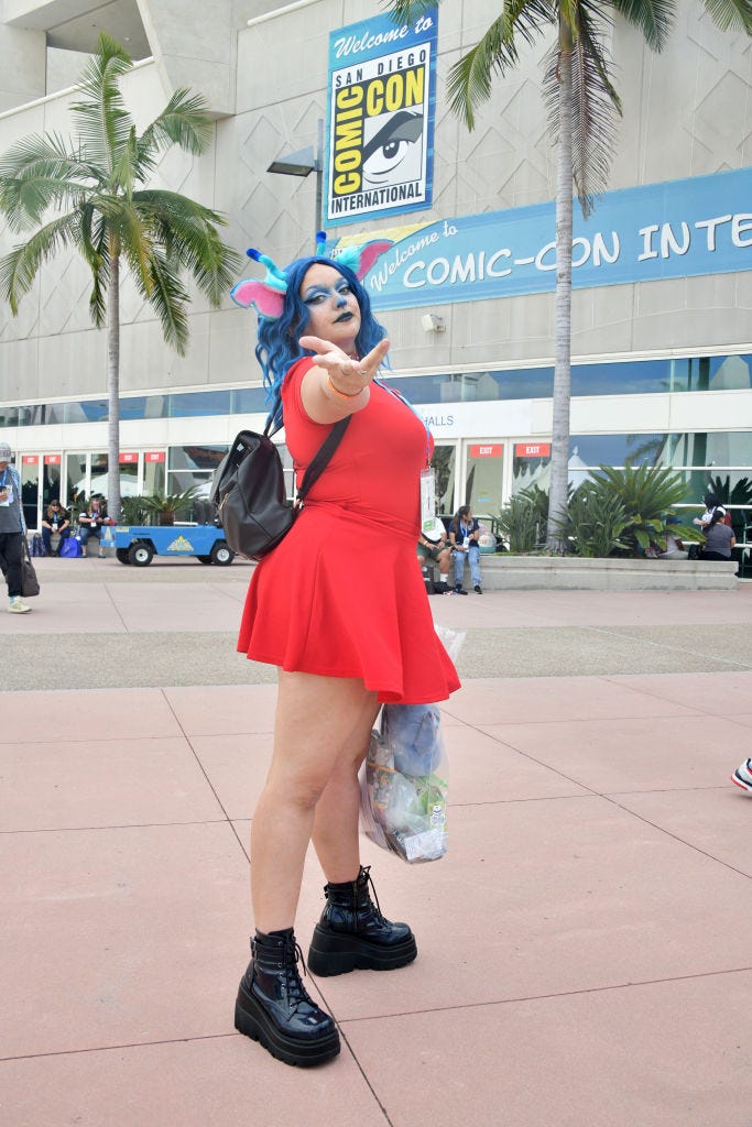 a cosplayer wears a stitch costume from lilo stitch at the 2022 comic con