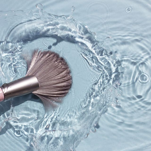 makeup brush in clean water with a splash