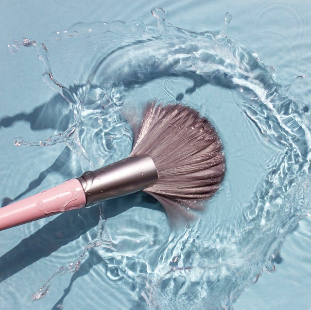 makeup brush in clean water with a splash