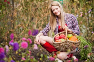 a person holding a basket of flowers