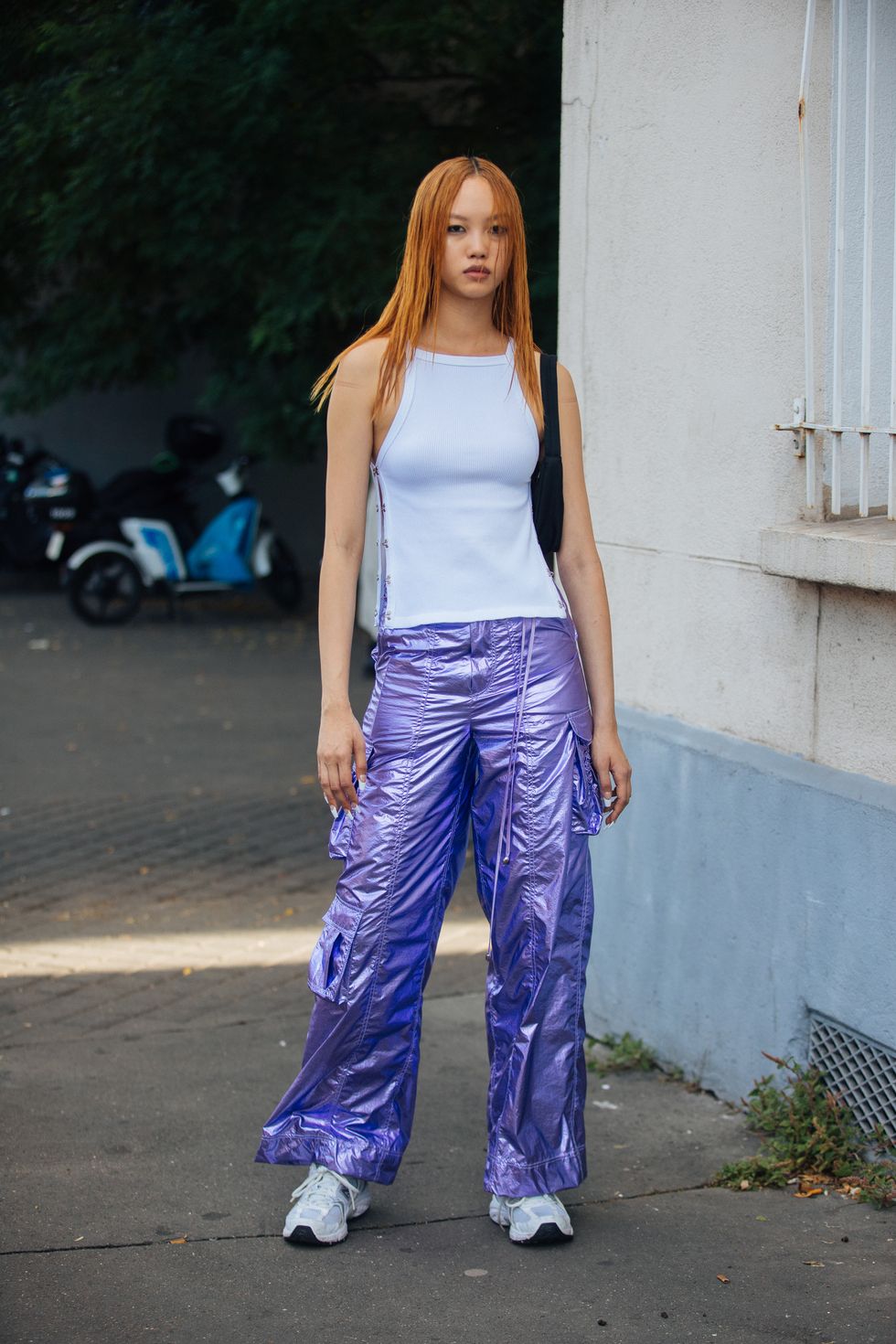 paris, france june 23 model jan baiboon wears a side clasp white tank top, metallic purple raver cargo pants, and white new balance sneakers after the rains show at le centquatre during paris fashion week mens springsummer 2023 on june 23, 2022 in paris, france photo by melodie jenggetty images