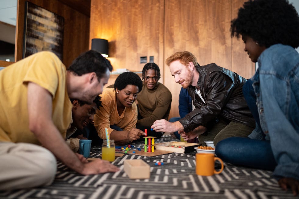 friends playing board game at home