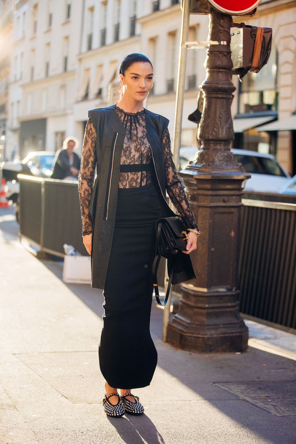 paris, france july 03 model mariacarla boscono wears a long black skinny leather zip up vest, black lace top, high waisted long maxi skirt,