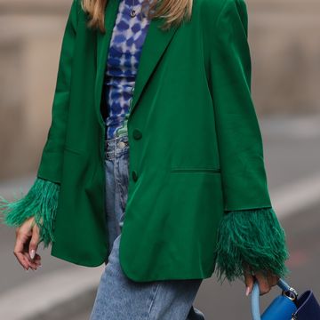 a person walking with a green coat