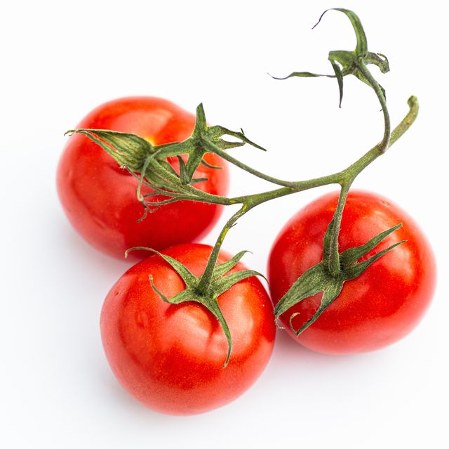 high angle shot of ripe tomatoes against white background
