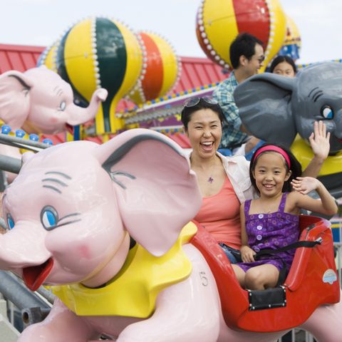 mother and daughter on ride at amusement park