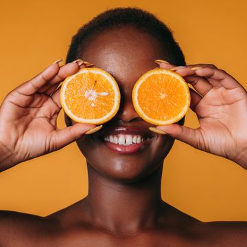 a man holding oranges